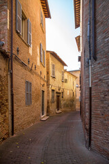 Fototapeta na wymiar Alleys of the city of Urbino, Marche, Italy. It was an important town of the Italian Renaissance. The streets are empty and no one is there.