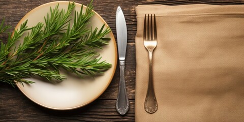 Holiday table setting with Christmas-themed flatlay, including green fir branches, linen napkin, and silverware, on a rustic tablecloth.