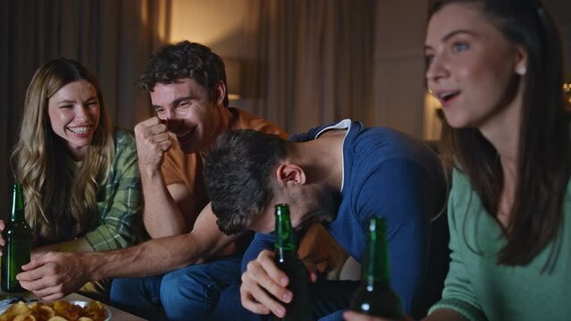 Smiling group people joking together at home gathering late evening close up.