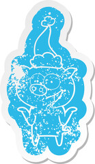 cartoon distressed sticker of a pig with no worries wearing santa hat