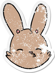 distressed sticker of a cartoon bunny face considering