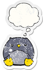 cartoon penguin and thought bubble as a distressed worn sticker