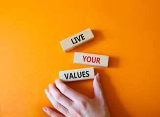 Live your values symbol. Concept words 'Live your values' on wooden blocks. Beautiful orange...