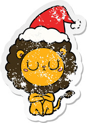 distressed sticker cartoon of a lion wearing santa hat
