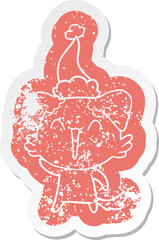 waving little dog cartoon distressed sticker of a wearing santa hat