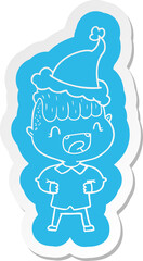 cartoon  sticker of a happy boy laughing wearing santa hat