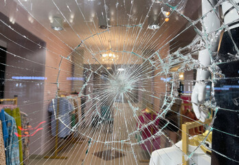 Broken window glass in a clothing store.