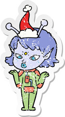 pretty distressed sticker cartoon of a alien girl wearing santa hat