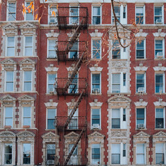 New York apartment blocks with fire escape at the front in New York City, USA.