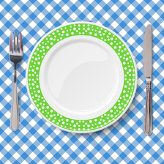 Green vector dish with pattern of chaotic white polka dot placed on blue classic table cloth