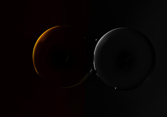 Two twin spheres softly illuminated against a void. 