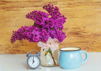 Obraz na płótnie Canvas Cup of Coffee for Good Morning and Purple Lilac .Have a great week message 