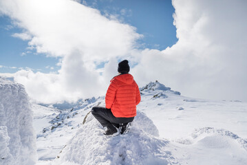 Beautiful woman with warm orange jacket  in the winter mountain .Vitosha ,Bulgaria 