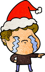 textured cartoon of a man crying wearing santa hat