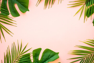 Fototapeta na wymiar Summer flat lay background. Tropical leaves, palm leaves and monstera on pink background.