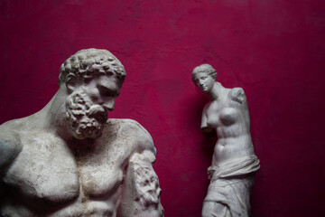 Plaster statue of ancient hero Hercules with sculpture of Aphrodite of Melos or Venus de Milo in...