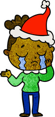 textured cartoon of a crying woman wearing santa hat