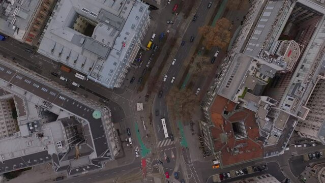High angle view of vehicles driving through winter town. Streets and large buildings in urban borough. Vienna, Austria