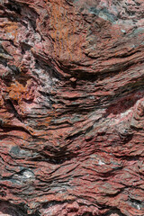 Fondo de piedra marina con colores rojos. Roca de Ushuaia, Patagonia Argentina