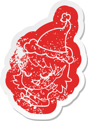 happy cartoon distressed sticker of a elf girl sitting wearing santa hat