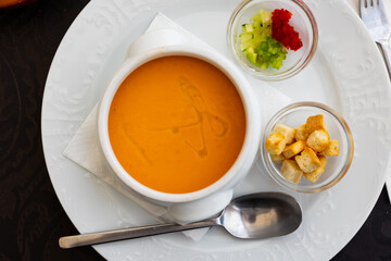Gazpacho, cold Spanish soup, served in bowl with croutons in restaurant.