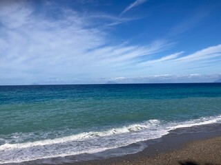 Fototapeta na wymiar Blue Sky with Clouds and Waves ‎⁨Sicily⁩, ⁨Capo d'Orlando⁩, ⁨Isole⁩, ⁨Italy⁩