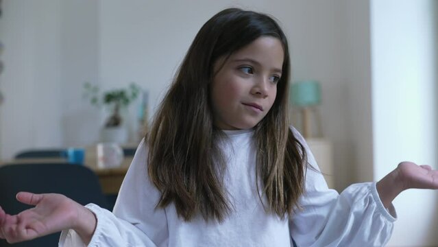 One confused little girl with bewildered expression clueless about what to do, undecided 8 year old child with puzzled portrait