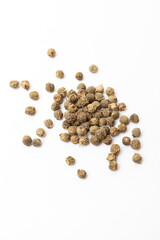 Green peppercorns on white background. Organic spice. Dry green pepper grain. 