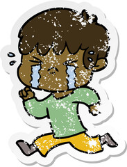 distressed sticker of a cartoon boy crying