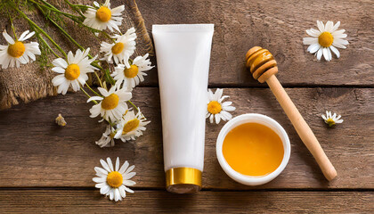Mockup. White plain tube of cream on a gray background; view from above with honey and chamomile.