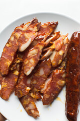 Top view of sliced chinese sausage, overhead view of sliced lap cheong sausage on white background