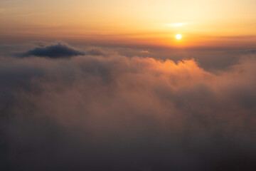 Fototapeta na wymiar The Sun sets over the Sea of Clouds in the Yellow Mountains of China.
