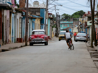 Urban landscape with classic car parked on a street in Trinidad, Cuba
