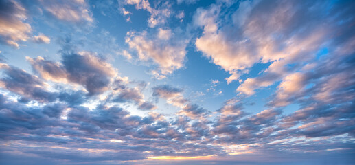 Panoramic background of evening sky with beautiful stormy clouds
