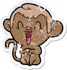 distressed sticker of a cartoon laughing monkey