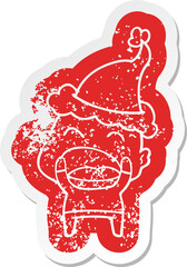 cartoon distressed sticker of a shouting bald man wearing santa hat