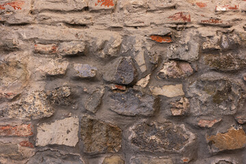 Old stone wall background. Texture of an ancient stone surface.