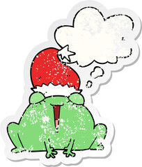 cute cartoon christmas frog and thought bubble as a distressed worn sticker