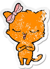 distressed sticker of a cartoon cat with bow on head