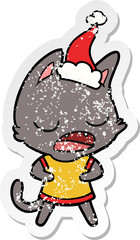 talking cat distressed sticker cartoon of a wearing santa hat