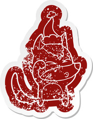 cartoon distressed sticker of a wolf pouting wearing santa hat