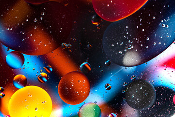 Colorful Oil Drops Bubbles and spheres. Flowing on Water Surface. Abstract background Macro...