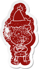 cartoon distressed sticker of a happy man wearing santa hat