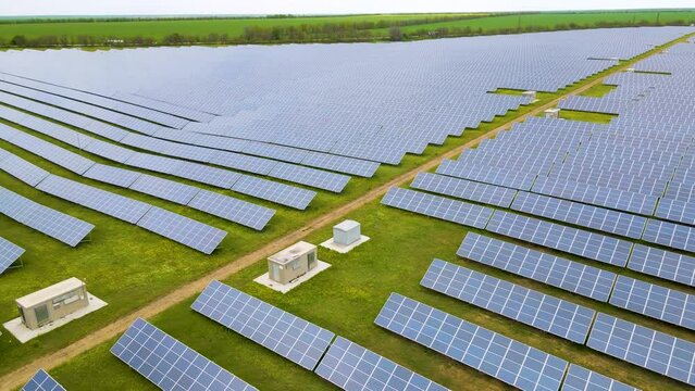 Aerial view of a large power plant with many rows of solar photovoltaic panels to produce clean electricity. Renewable electricity with zero emissions