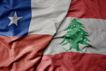 big waving national colorful flag of lebanon and national flag of chile .