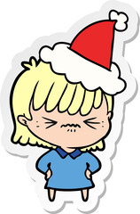 annoyed sticker cartoon of a girl wearing santa hat