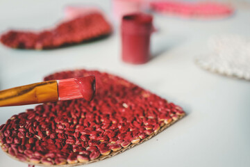 Children's creativity from heart-shaped cereals top view, fine motor skills development concept