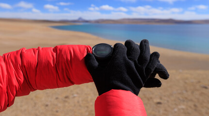 Hiker on high altitude mountain top checking the altimeter on the sports watch