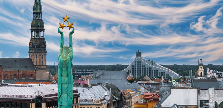 Beautiful sunrise view over Riga by the statue of liberty - Milda in Latvia. The monument of freedom.