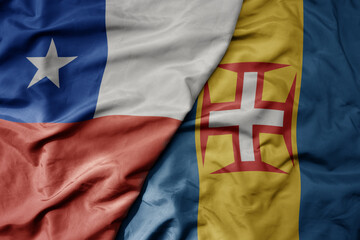 Fototapeta premium big waving national colorful flag of madeira and national flag of chile .